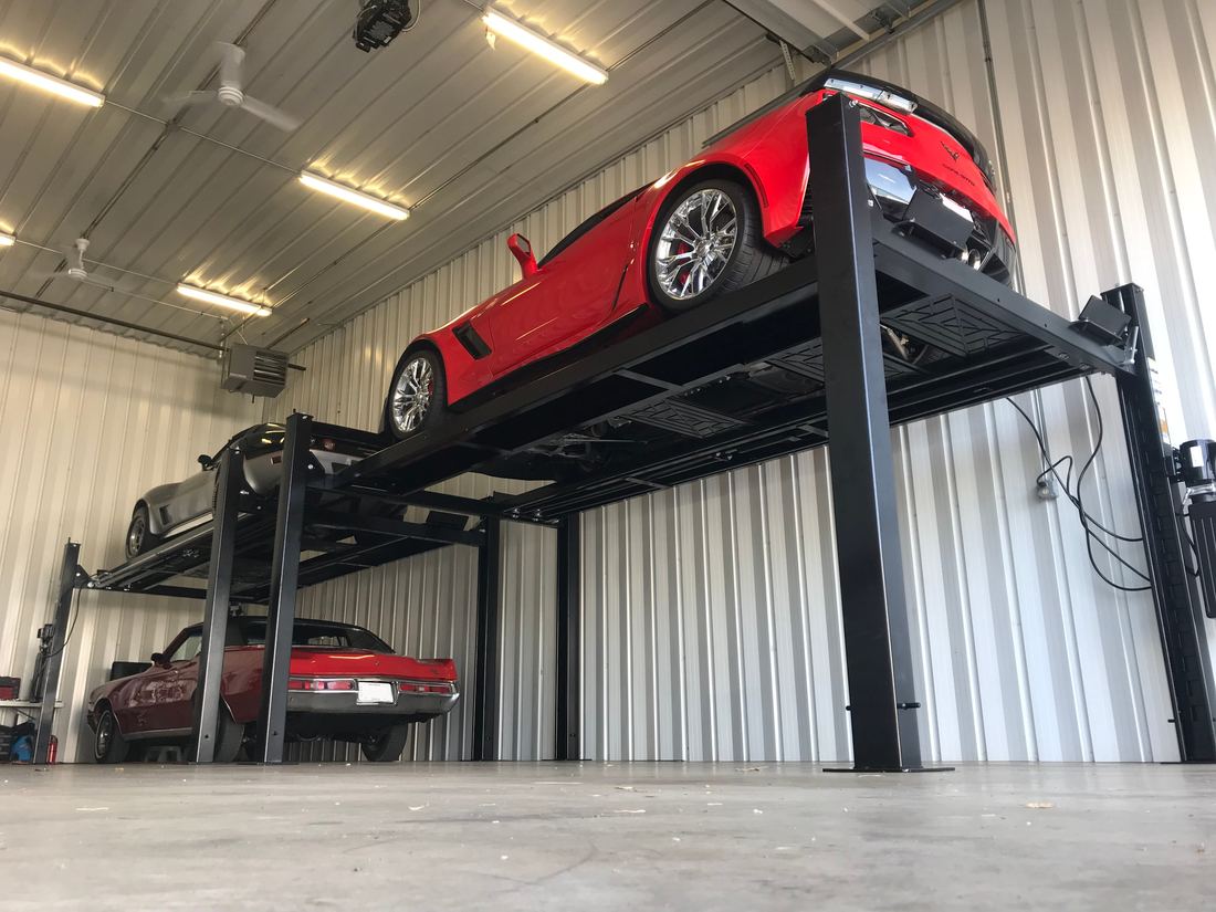 Sports cars stored two-high on Challenger Home Storage lifts